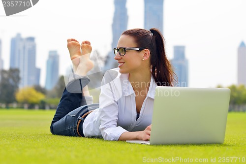 Image of woman with laptop in park