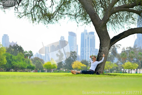 Image of woman with laptop in park