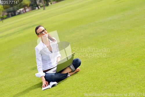 Image of woman with laptop in park