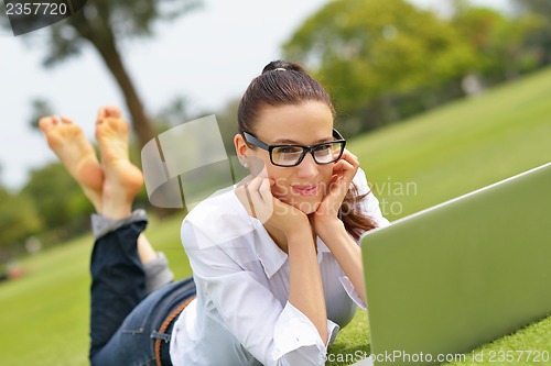 Image of woman with laptop in park
