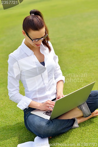 Image of woman with laptop in park