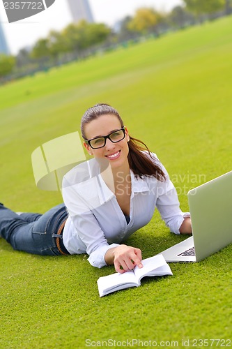 Image of woman with laptop in park