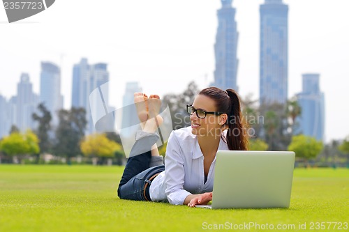 Image of woman with laptop in park