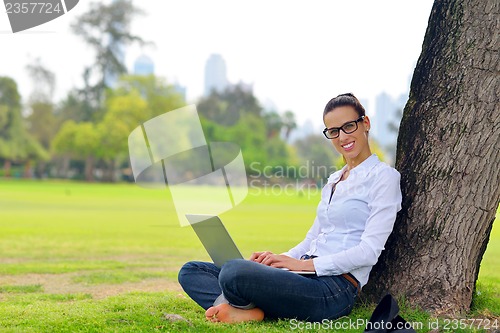 Image of woman with laptop in park