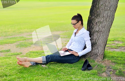 Image of woman with laptop in park