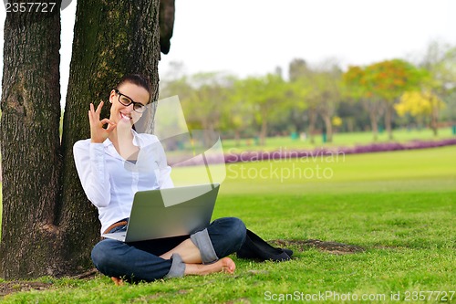 Image of woman with laptop in park