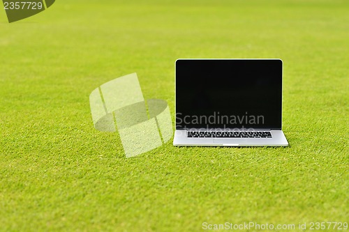 Image of laptop computer  on grass