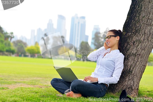 Image of woman with laptop in park