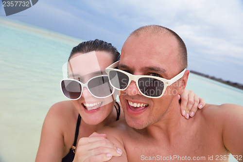 Image of happy young  couple at summer vacation have fun and relax at bea