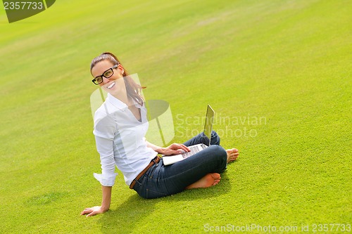 Image of woman with laptop in park