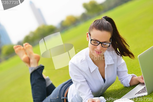 Image of woman with laptop in park