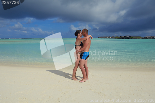 Image of happy young  couple at summer vacation have fun and relax at bea