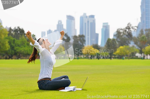 Image of woman with laptop in park