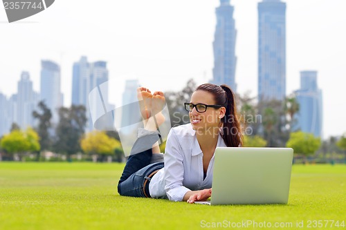 Image of woman with laptop in park