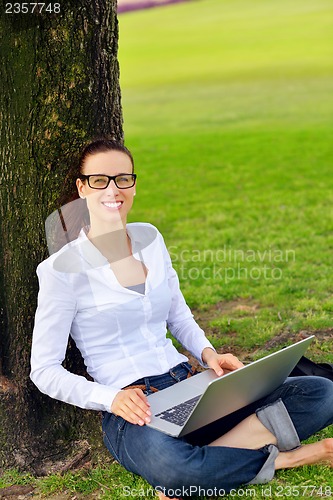 Image of woman with laptop in park