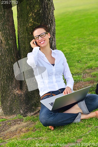 Image of woman with laptop in park