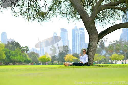 Image of woman with laptop in park