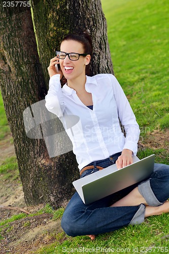 Image of woman with laptop in park