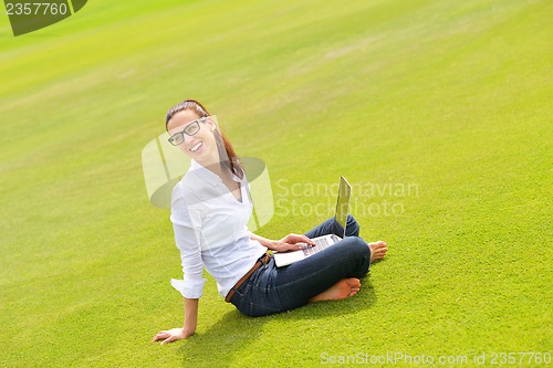 Image of woman with laptop in park