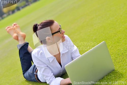 Image of woman with laptop in park