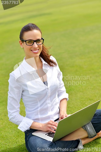 Image of woman with laptop in park