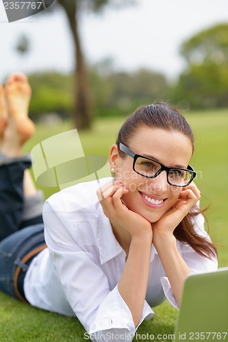 Image of woman with laptop in park
