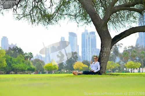 Image of woman with laptop in park