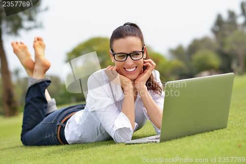 Image of woman with laptop in park