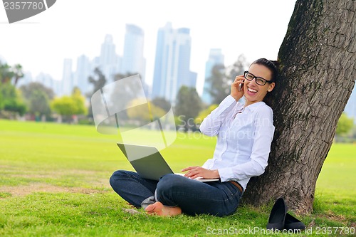Image of woman with laptop in park