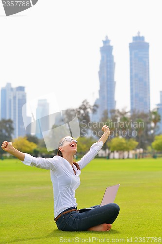 Image of woman with laptop in park