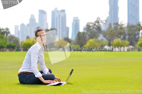 Image of woman with laptop in park