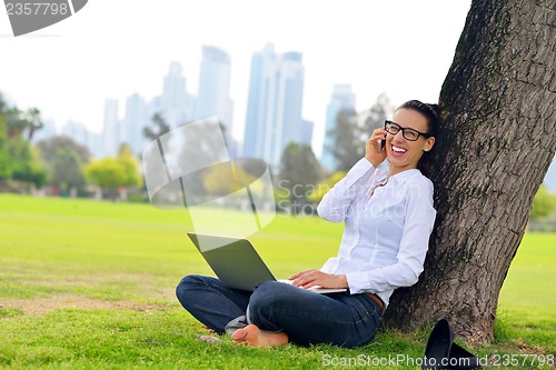 Image of woman with laptop in park
