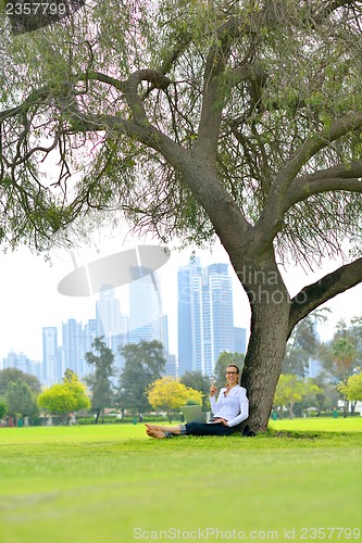 Image of woman with laptop in park