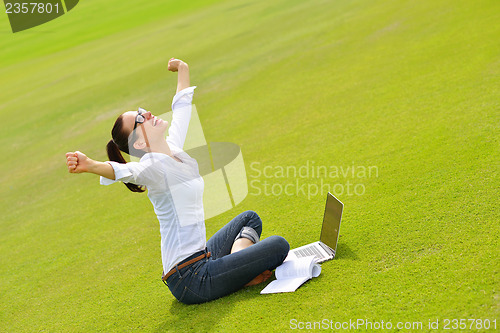 Image of woman with laptop in park