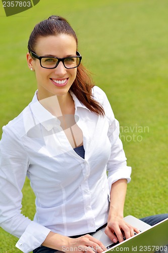 Image of woman with laptop in park