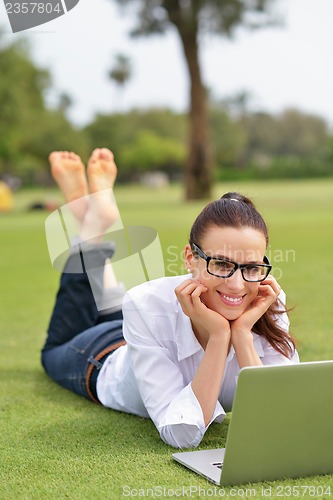 Image of woman with laptop in park