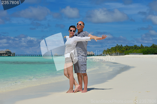 Image of happy young  couple at summer vacation have fun and relax at bea