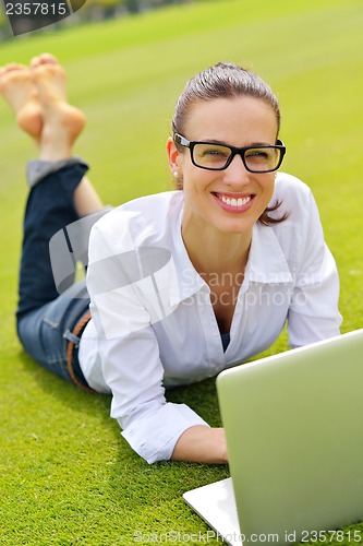 Image of woman with laptop in park