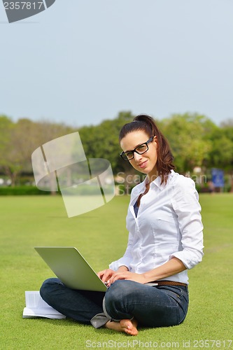 Image of woman with laptop in park