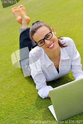 Image of woman with laptop in park