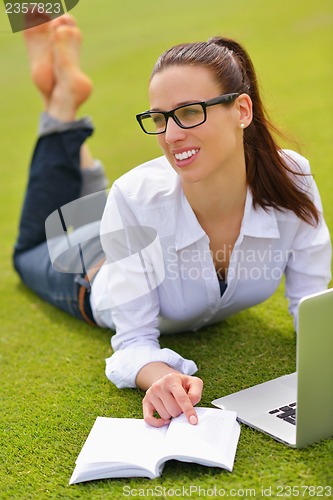 Image of woman with laptop in park