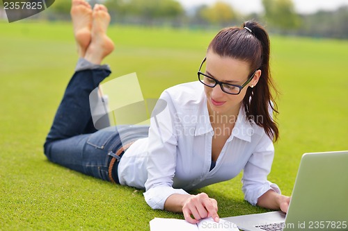 Image of woman with laptop in park