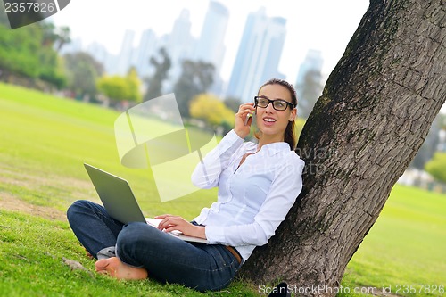 Image of woman with laptop in park