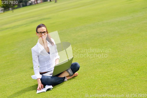 Image of woman with laptop in park