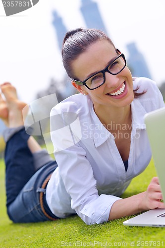 Image of woman with laptop in park