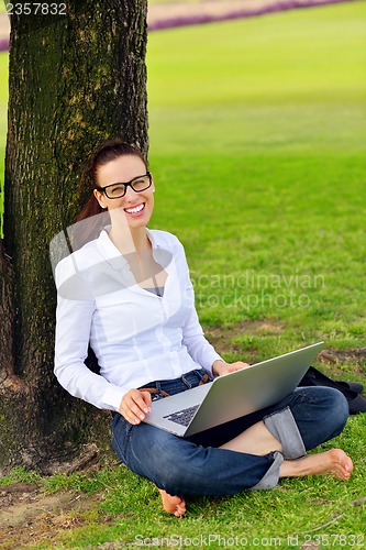 Image of woman with laptop in park