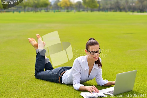 Image of woman with laptop in park