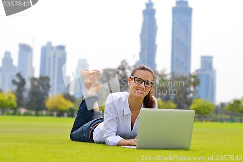 Image of woman with laptop in park