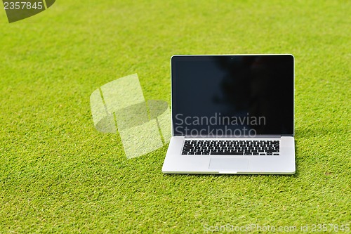 Image of laptop computer  on grass