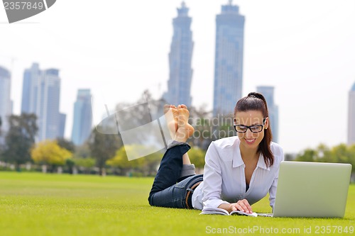 Image of woman with laptop in park